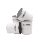 Stack of white cups with 'Uncharted' branding on a white background