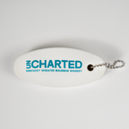 White oval keychain with 'Uncharted' branding on a white background